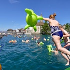 F0X52H Zurich, Switzerland. 22nd August, 2015. Swimmers are jumping into Zurich's cool Limmat river to drift down 2km through the city. Sunny weather and warm temperatures at Zurich's traditional "Limmatschwimmen" ("swim down the Limmat river") attracted 4500 swimmers who, equipped with rubber turtles and other fancy floating devices, enjoyed drifting down the river through Zurich. Credit: Erik Tham/Alamy Live News
F0X52H Zurich, Switzerland. 22nd August, 2015. Swimmers are jumping into Zurich's cool Limmat river to drift down 2km through the city. Sunny weather and warm temperatures at Zurich's traditional Limmatschwimmen (swim down the Limmat river) attracted 4500 swimmers who, equipped with rubber turtles and other fancy floating devices, enjoyed drifting down the river through Zurich. Credit: Erik Tham/Alamy Live News
F0X52H
water, fun, event, Limmat, river, swim, refreshment, jump, Zurich, event, river, Limmat, city, swimming, swimmer, swim, water, gathering, fun, sports, water, many, people, enjoy, drift, jump, floating, device, Limmatschwimmen, happiness, outdoors, splash, jumping, cool, action, afloat, bath, bathing, summer, hot, refreshment, refreshing, recreation, Crowded, Europe, Limmat, Limmatschwimmen, Switzerland, Zurich, busy, crowd, drift, enjoy, event, float, floating, device, fun, fun, event, funny, gathering, happy, jump, many, many, people, mass, gathering, odd, outdoors, people, river, rubber, duck, slow, splash, sports, swim, swimmer, swimming, traditional, water, water, sports
Swimmers are jumping into Zurich's cool Limmat river to drift down 2km through the city.