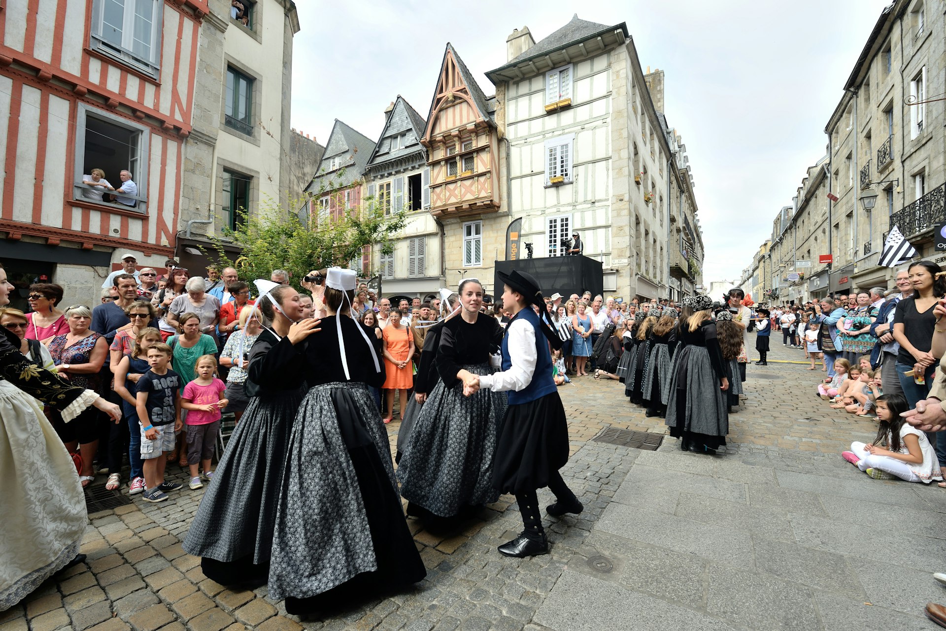 Participants in traditional Breton dress dance at the festival de Cornouailles, Quimper, Brittany France
