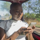 Woman in fitness, epidemiologist, biostatistician, business woman, strong African woman, African original, Strong, Badass, Bold, Energetic
1063306764
Woman using a mobile phone in a taxi - stock photo
Woman in fitness, epidemiologist, biostatistician, business woman, strong African woman, African original, Strong, Badass, Bold, Energetic