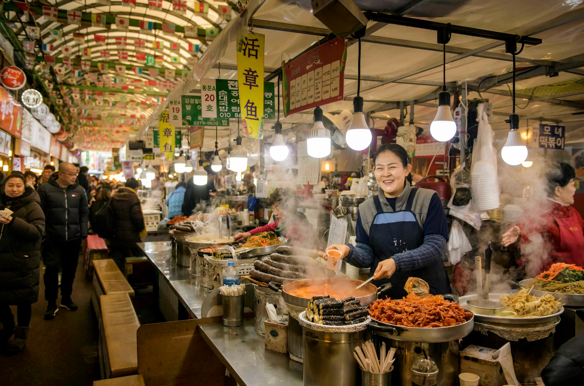 A vendor prepares food at a market in Seoul, South Korea