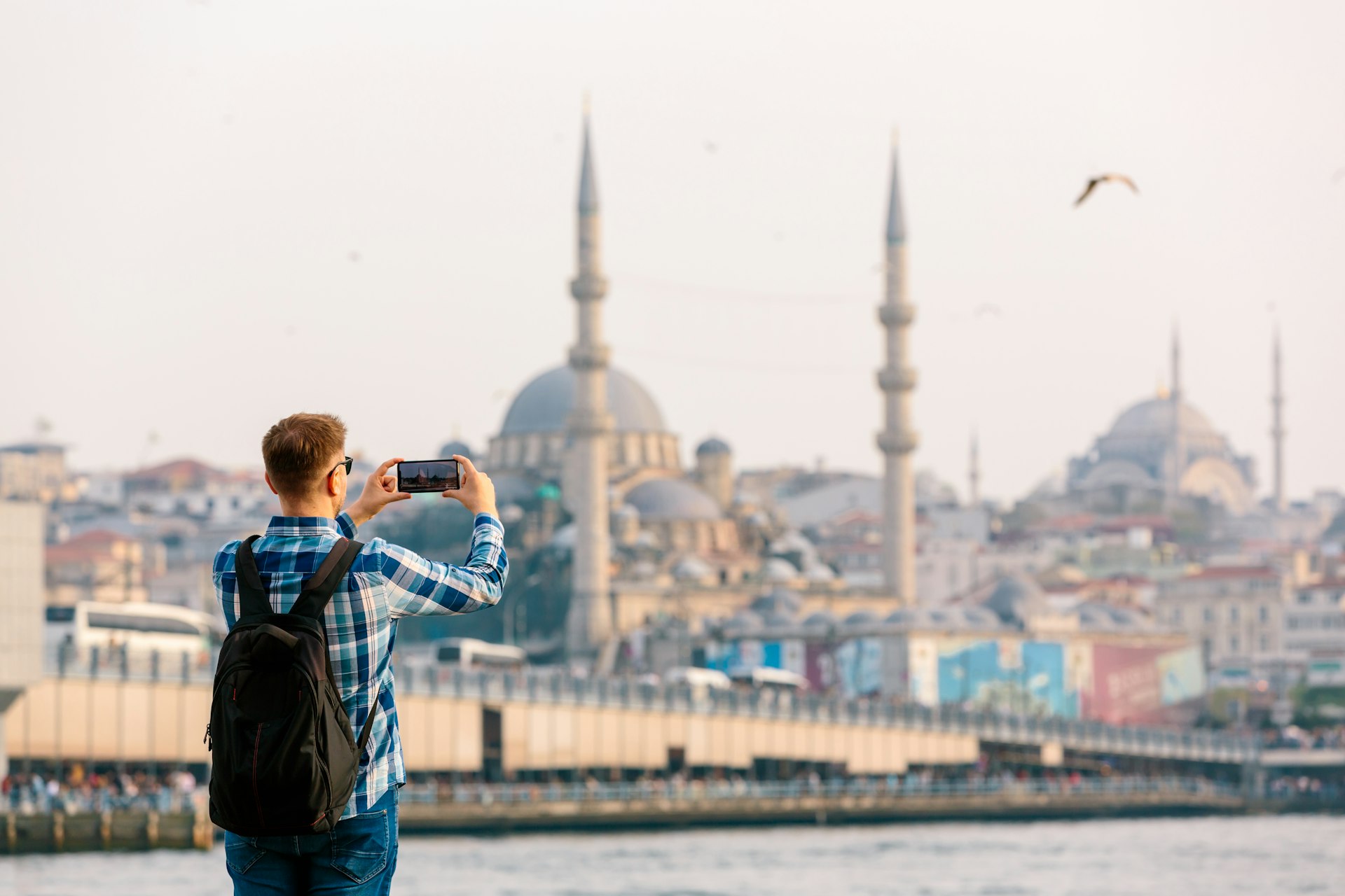 Man takes a photo of the Hagia Sophia from a viewpoint