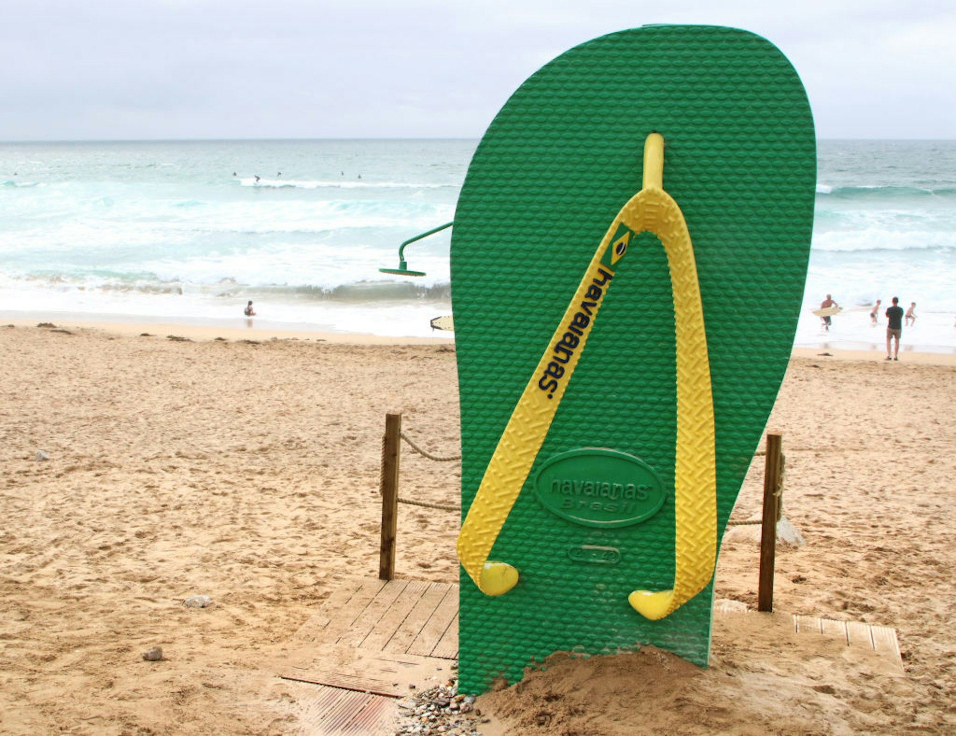 A huge advertising replica of a Havaianas 'flip flop' used at the beach side as a shower, on Fistral Beach, Newquay..UK's centre of Surfing is around the varied coastline and beaches of Cornwall in the very south west of the mainland. Surfers head there every summer and there