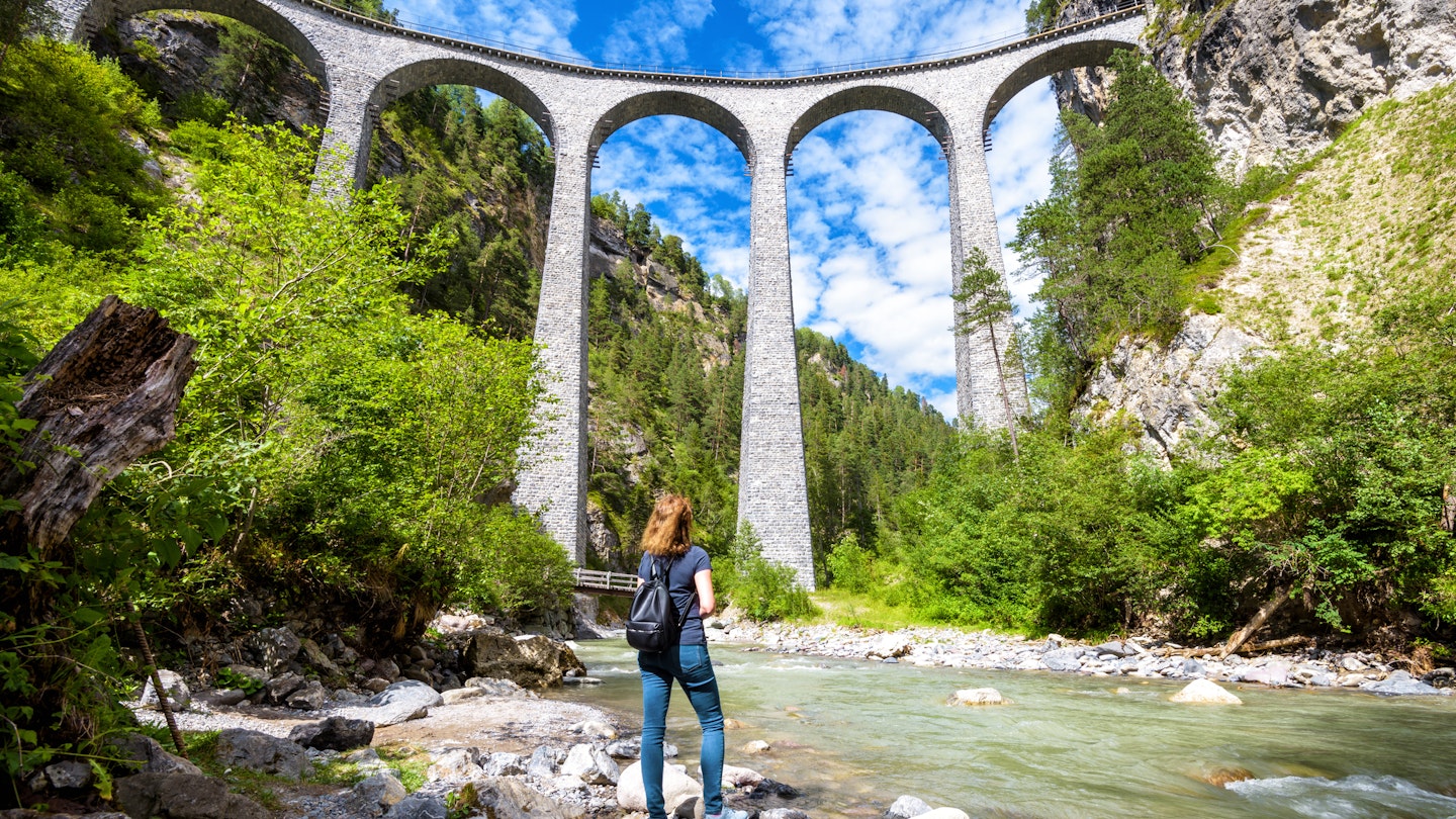Landwasser Viaduct in Filisur, Switzerland. Young woman looks at the famous tourist attraction. Scenic panorama of high railway bridge in mountains. Adult girl travels in Swiss Alps in summer.
1176201948
rhaetian, landwasser, filisur, express, bernina