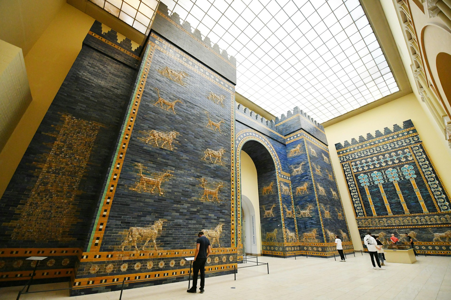 A visitor in front of the Ishtar Gate, Pergamonmuseum, Berlin, Germany