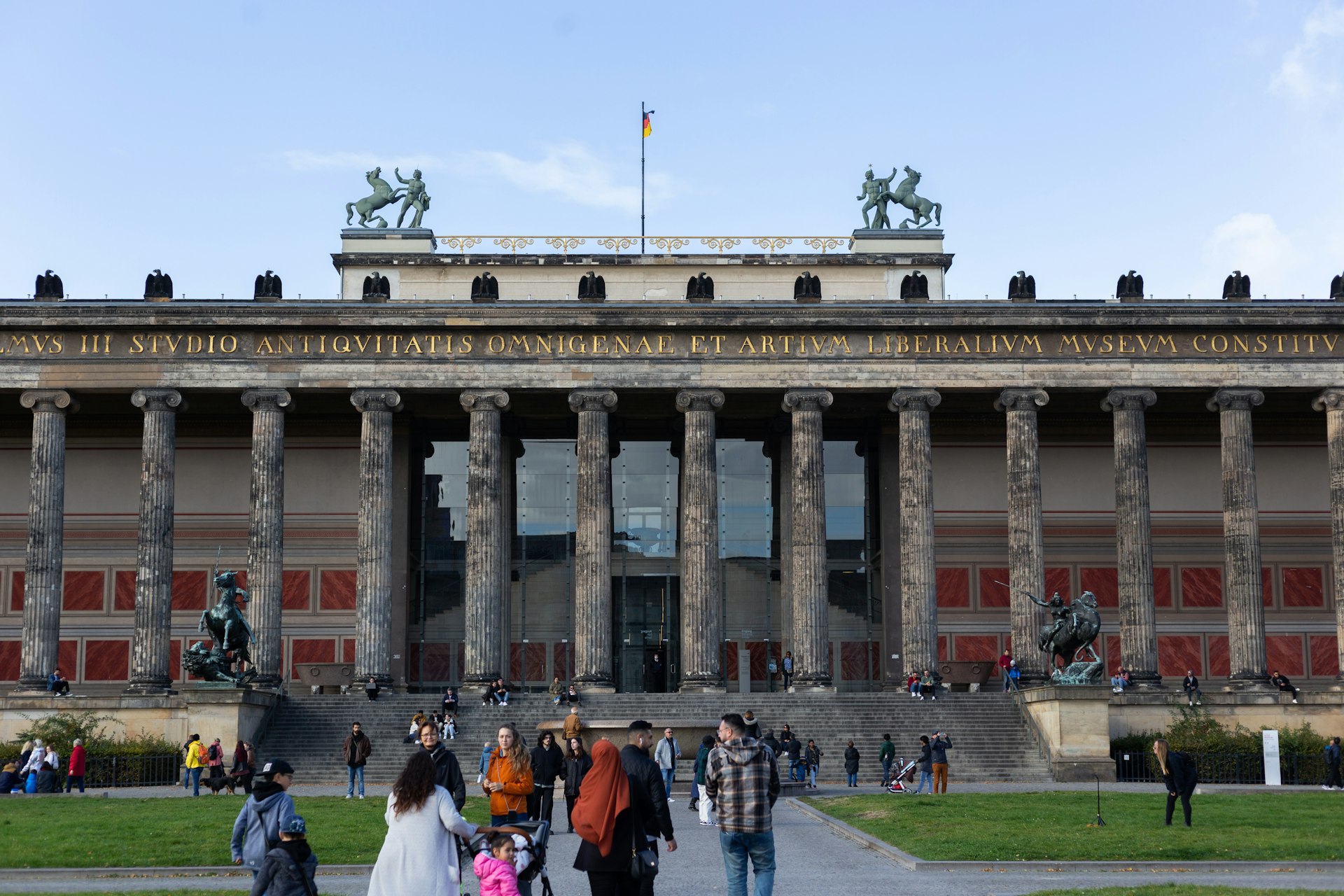People congregate in front of the Classical facade of the Altes Museum, Berlin, Germany