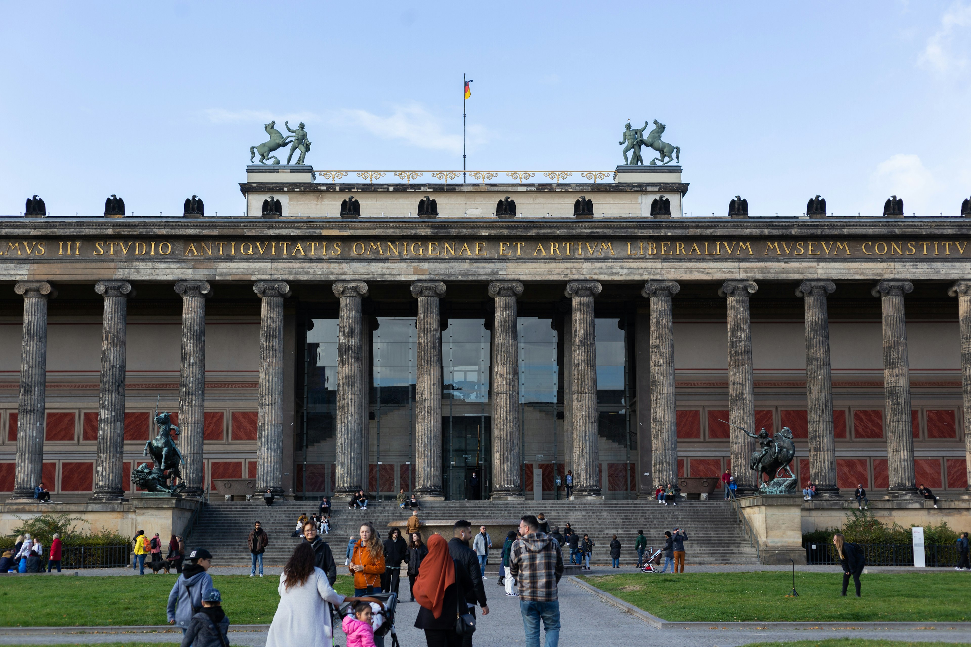 People congregate in front of the Classical facade of the Altes Museum, Berlin, Germany