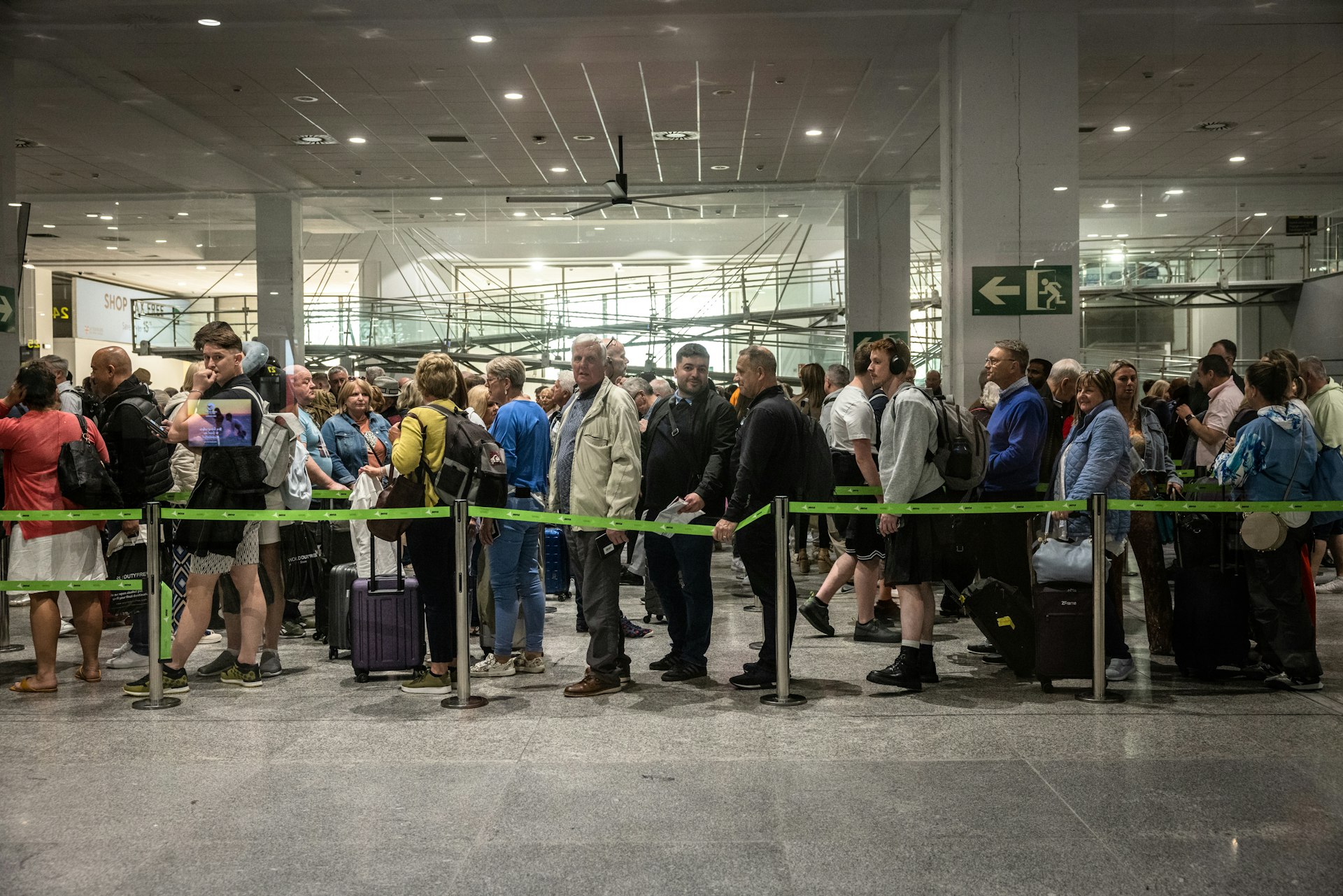 Passengers queue in the departures hall in Malaga-Costa del Sol airport, Malaga, Spain