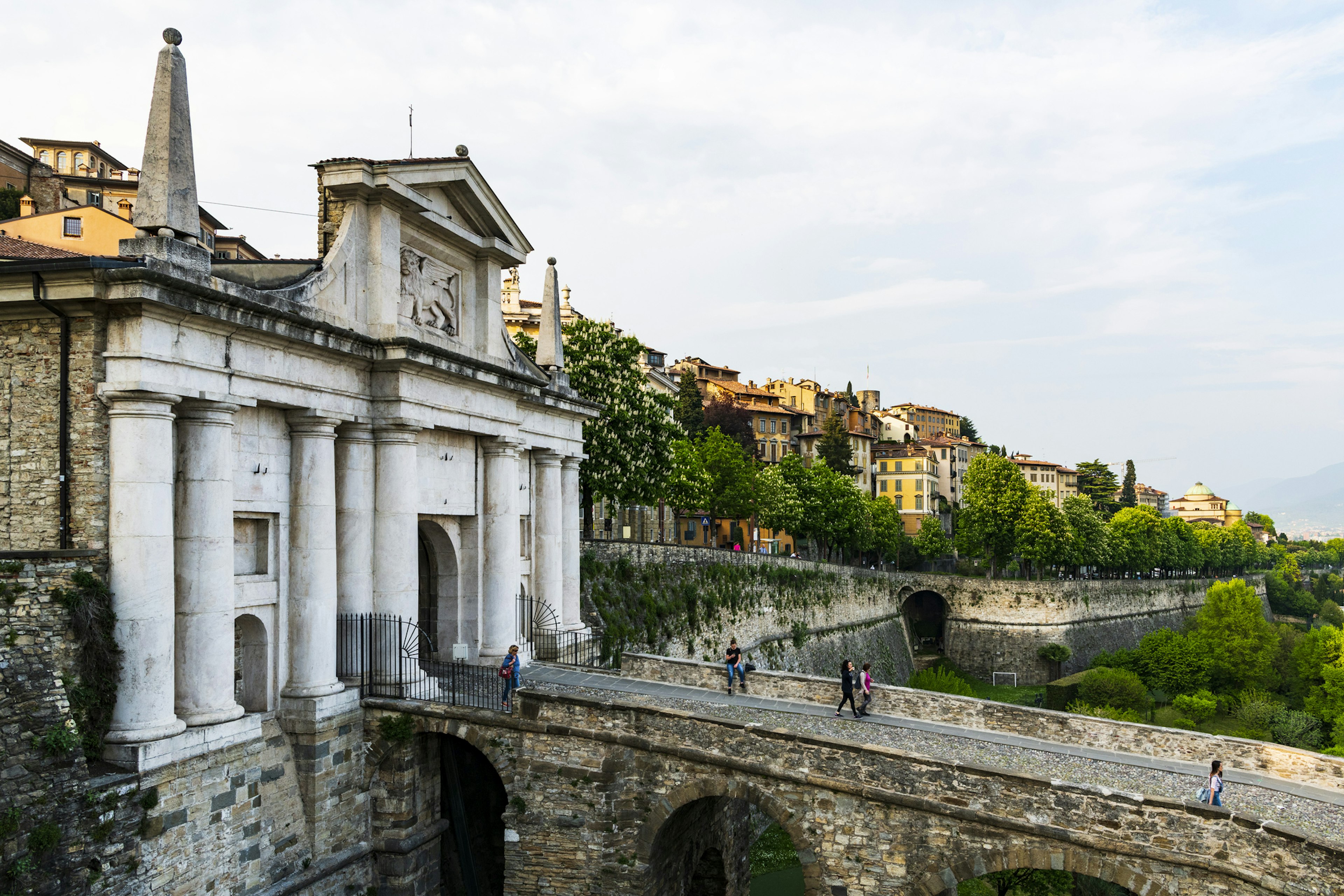 A large Venetian city gate outside of an Italian city.