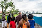 Rear View Following a Group of Cheerful, Fashionable Afro-Descendant Black Tourists Walking Together Taking in a View of Panama City, Panama from Plaza V Centenario with Copy Space
1426692017
A group of travelers on a walking tour of Panama City