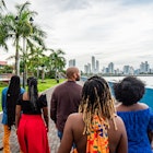 Rear View Following a Group of Cheerful, Fashionable Afro-Descendant Black Tourists Walking Together Taking in a View of Panama City, Panama from Plaza V Centenario with Copy Space
1426692017
A group of travelers on a walking tour of Panama City