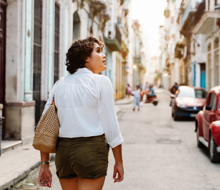 Cuban girl walking down street in Havana, exploring the city with curiosity
1456178960