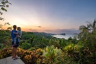 Father and toddler daughter enjoying a vibrant sunrise over the wild untamed coastal beauty of Manuel Antonio National Park on the Pacific Coast of Costa Rica.
1474914256