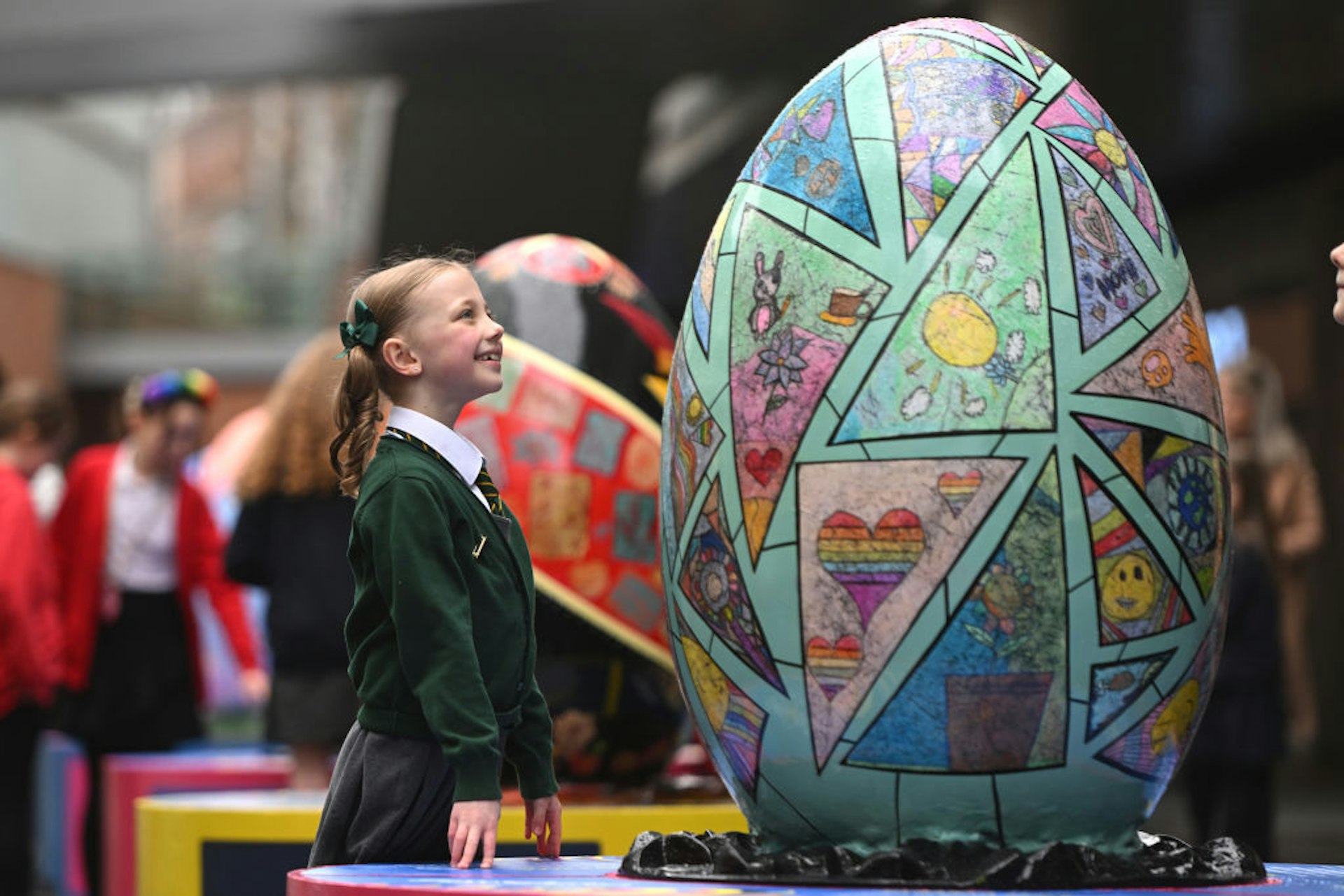 A young school girl looks at a decorated Ukrainian egg in Liverpool. 