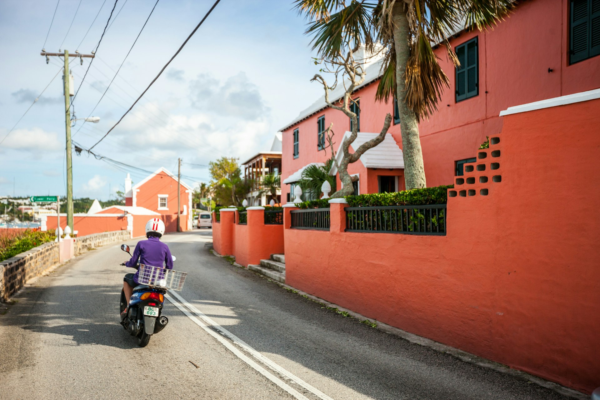 Woman driving Motorcycle on Hamilton street, Bermuda