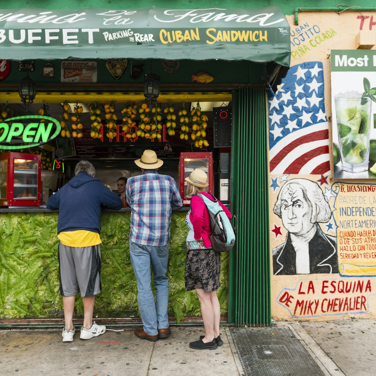 Miami, United States - March 21, 2016: Tourists stand to order from the open air countertop of a restaurant advertising Cuban food and drinks on historic Calle Ocho in Little Havana.