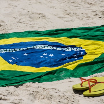 brazilian flag and havaianas at Copacabana's beach , Rio de Janeiro, Brazil on Tuesday February 18th, 2014 (Photo by Paulo Fridman/Corbis via Getty Images)
542647306
sand:CB2, flag:CB2, beach:CB2, Copacabana:CB2, sun:CB2, rj:CB2, sun.:CB2