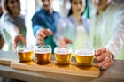 Friends reaching towards beer sampler at bar counter
653202164
Beer, Bar, Counter Top, Glass, Wood