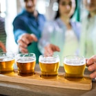 Friends reaching towards beer sampler at bar counter
653202164
Beer, Bar, Counter Top, Glass, Wood