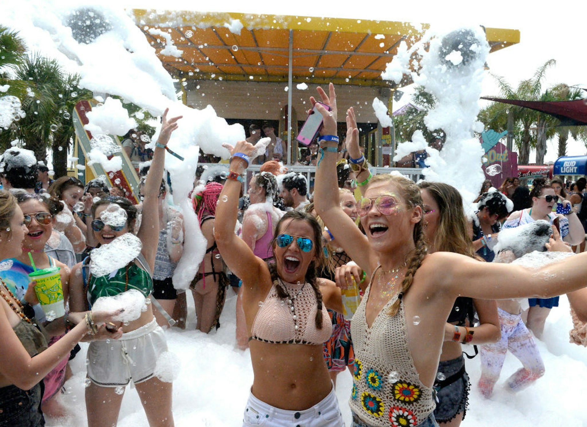Festivalgoers party in foam at a music festival. 