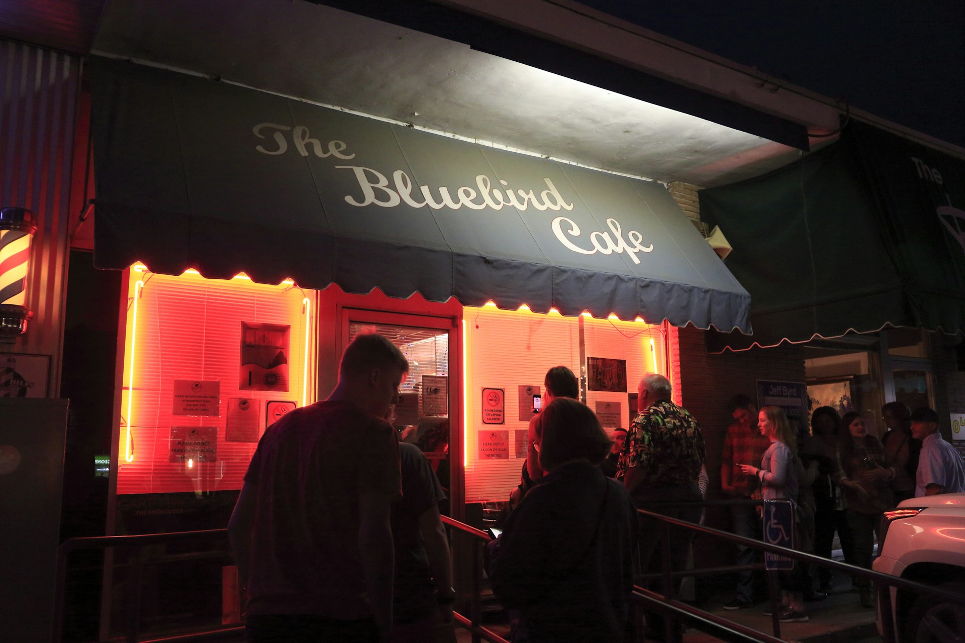 People waiting in line to get into the famous Bluebird Cafe musical club at night