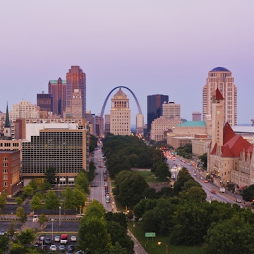 Downtown St Louis skyline at dusk, featuring the Gateway Arch.