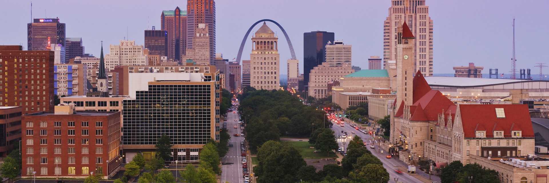 Downtown St Louis skyline at dusk, featuring the Gateway Arch.