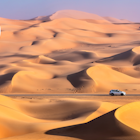 Driving through Rub al Khali Desert, also known as the Empty Quarter, in UAE.