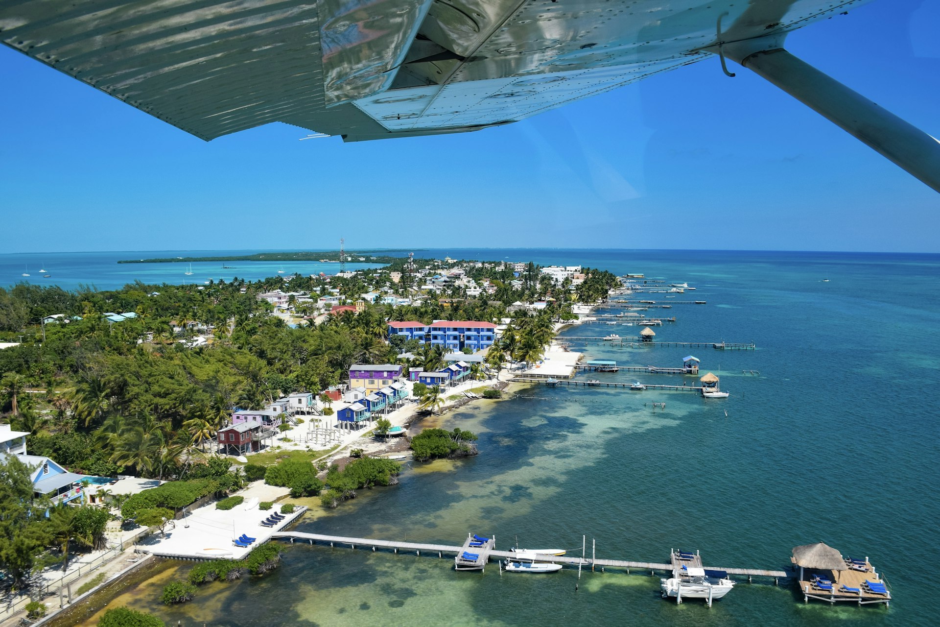 Caye Caulker from above with plane wing in foreground