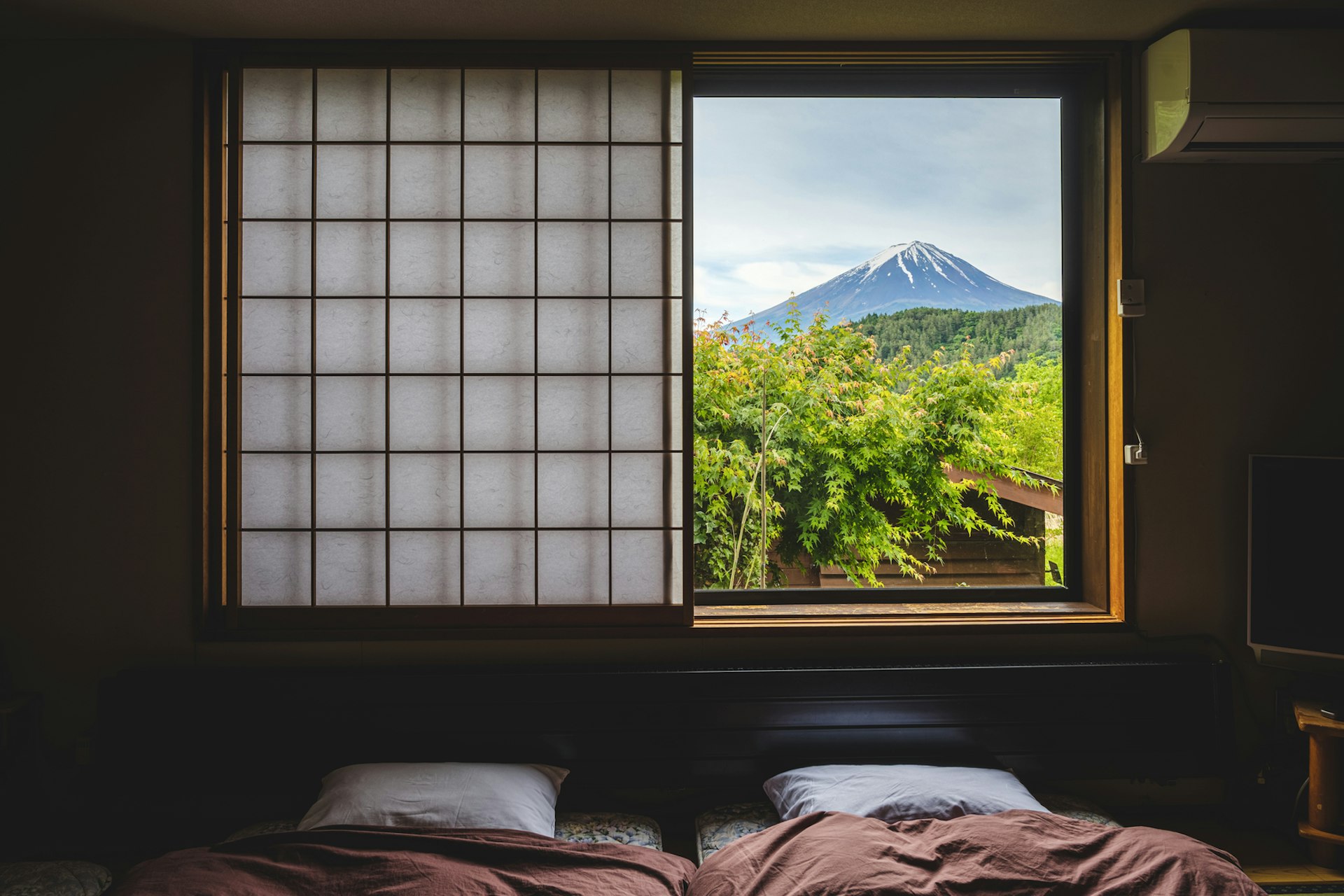 A view of Mt Fuji through the window of a Japanese inn, called a ryokan, on Lake Kawaguchi, Japan