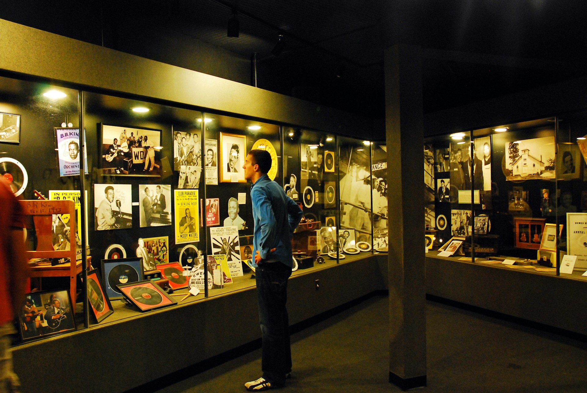 A man looks at old records, posters and photos encased in a large display at Sun Studios in Memphis, Tennessee, USA