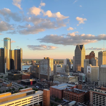 The setting sun in Detroit Michigan casting beautiful light on the skyline downtown. A sliver of the Detroit River is visible between the buildings, and Windsor, Ontario, Canada can be seen in the background. This image was captured from an elevated position.
1407950728