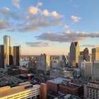 The setting sun in Detroit Michigan casting beautiful light on the skyline downtown. A sliver of the Detroit River is visible between the buildings, and Windsor, Ontario, Canada can be seen in the background. This image was captured from an elevated position.
1407950728