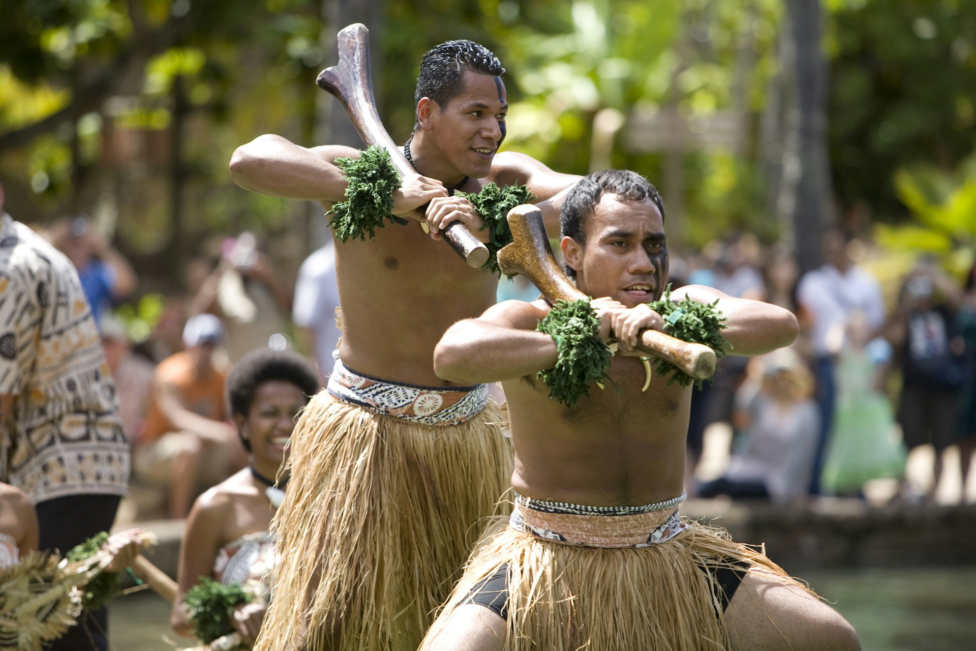 Students from Fiji perform traditional Fijian dances on a canoe. 