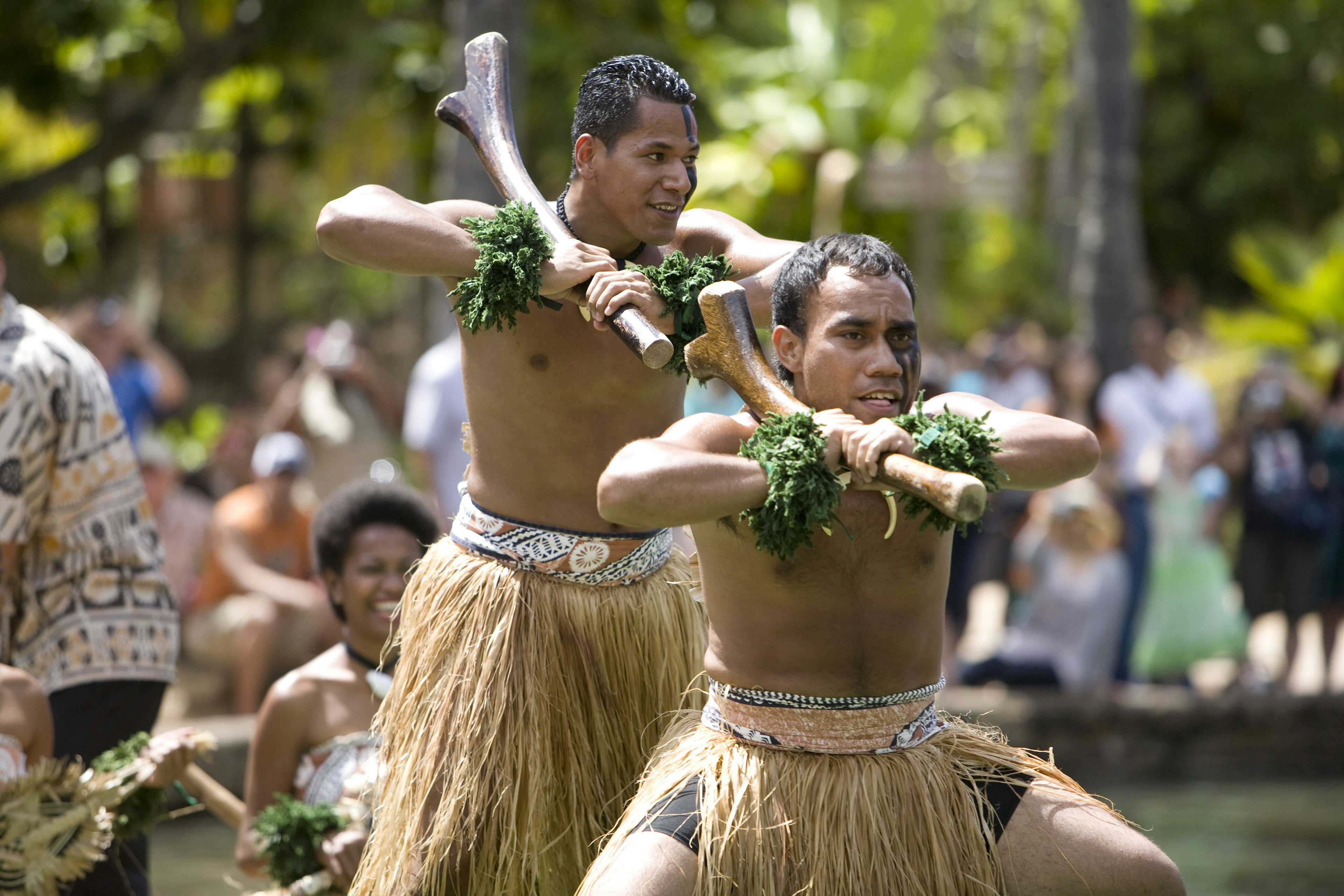 Students from Fiji perform traditional Fijian dances on a canoe.