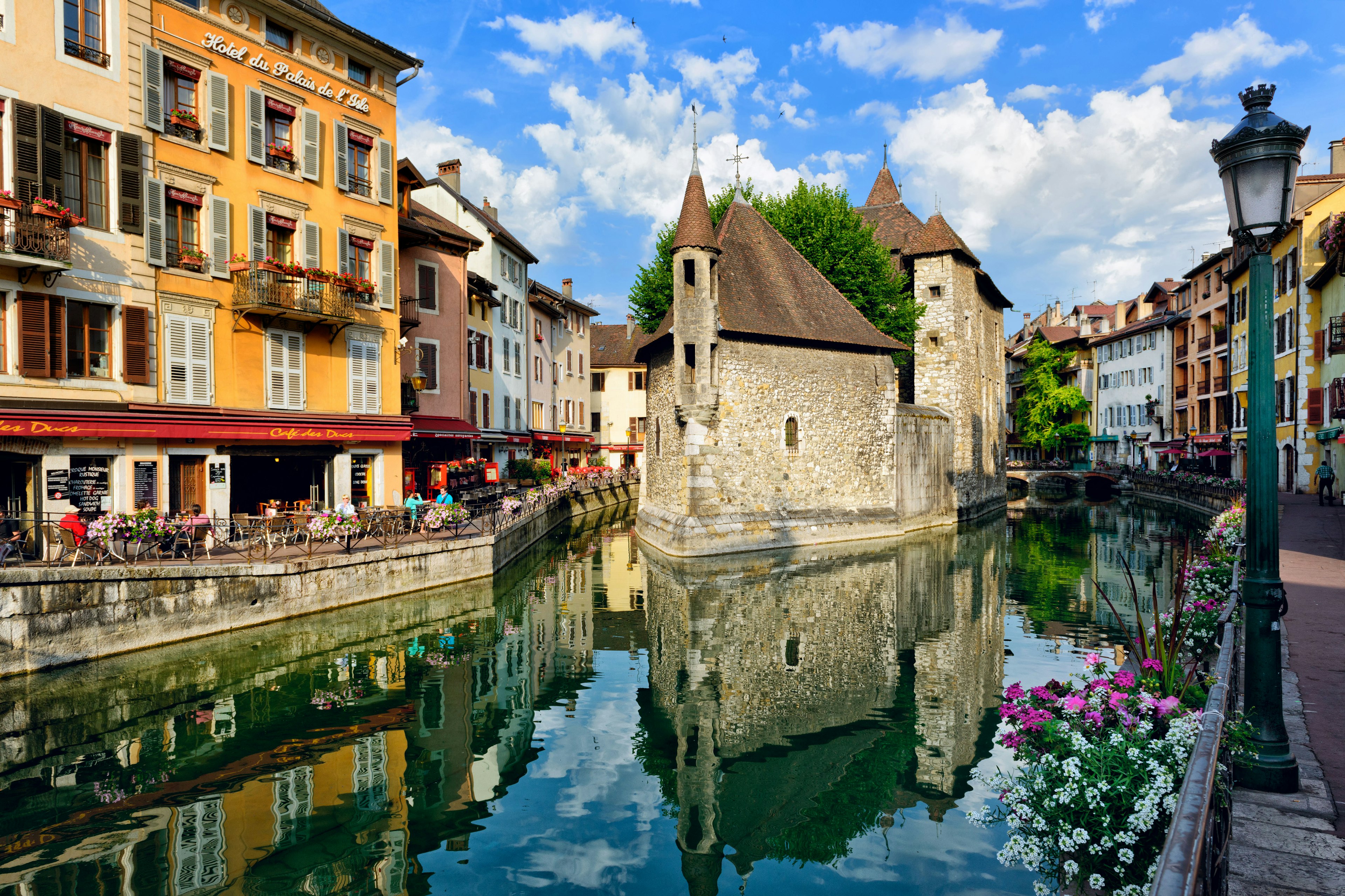 A canal runs through a medieval town center