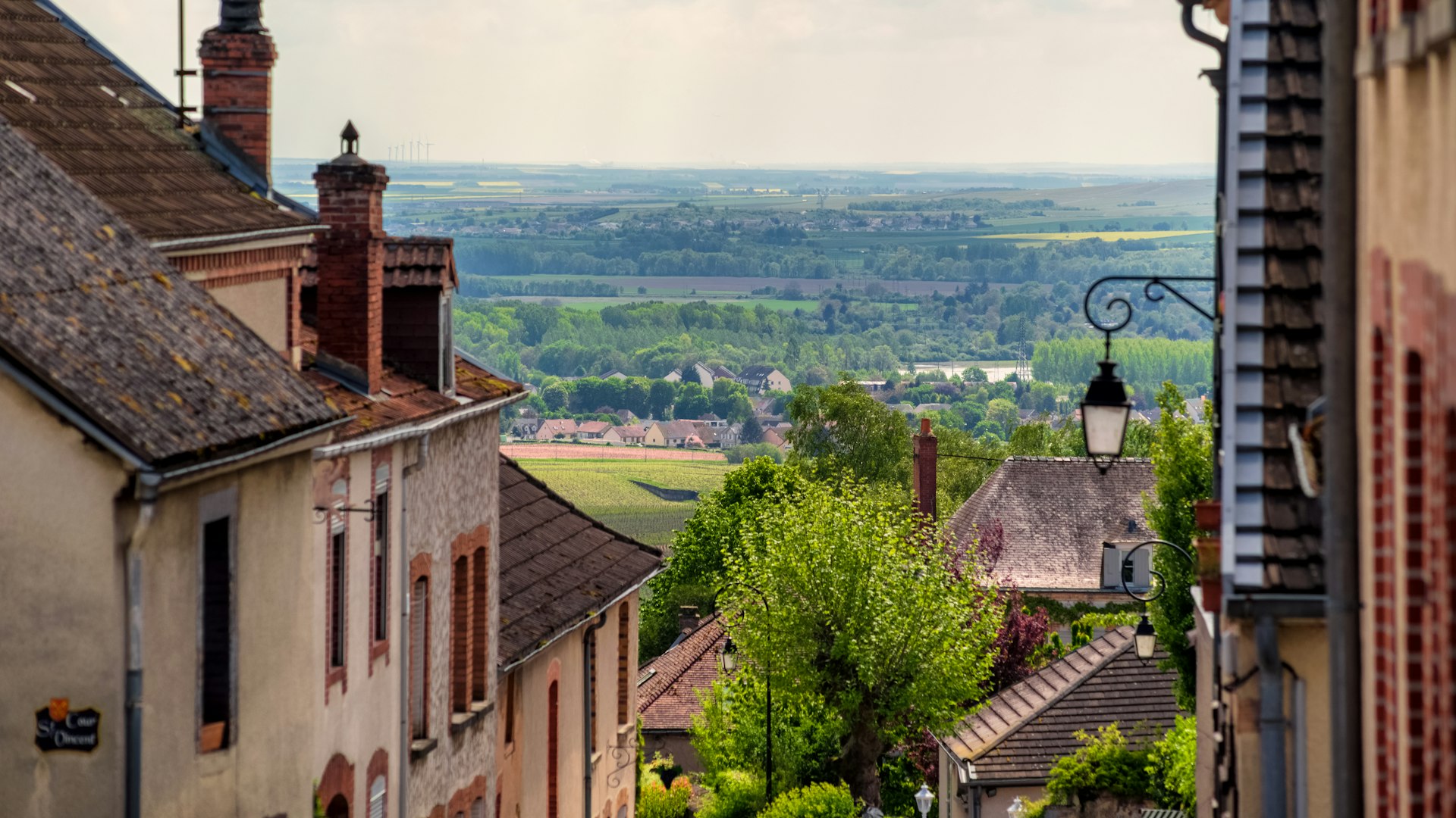 Brown roofs and buildings of Hautvillers, in the Champagne region of France, looking out on vineyards and hills