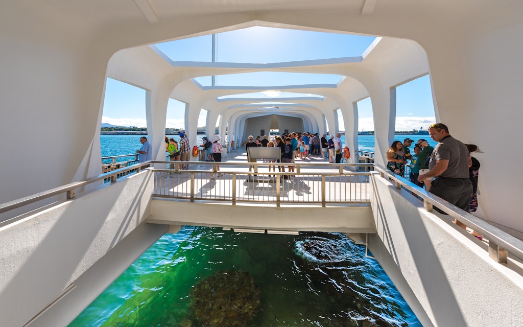 The USS Arizona Memorial straddles the sunken hull of the battleship without touching it. 