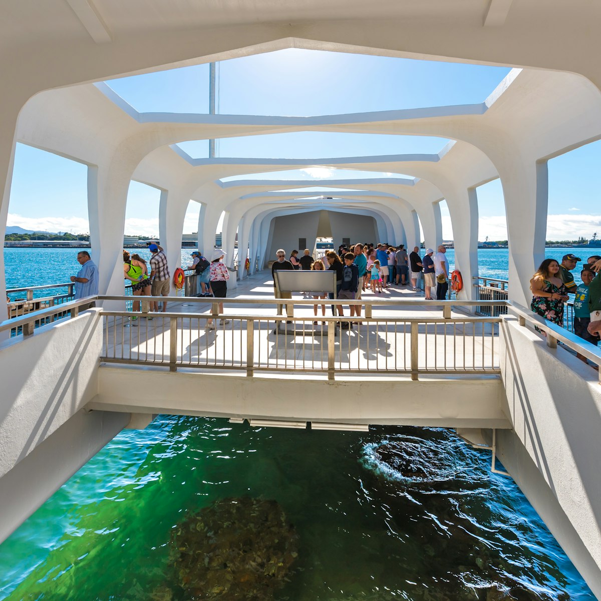 The USS Arizona Memorial straddles the sunken hull of the battleship without touching it. 