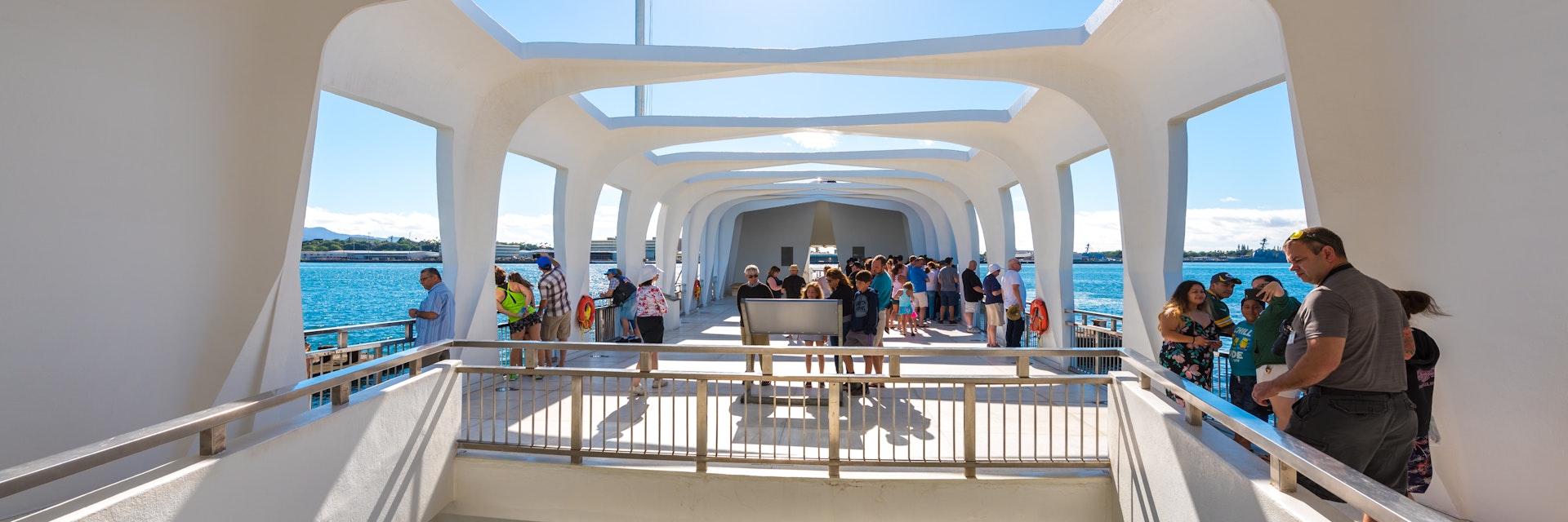 The USS Arizona Memorial straddles the sunken hull of the battleship without touching it.
