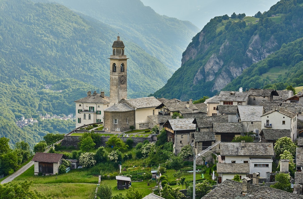 Church and old houses of mountain village Soglio, Switzerland.