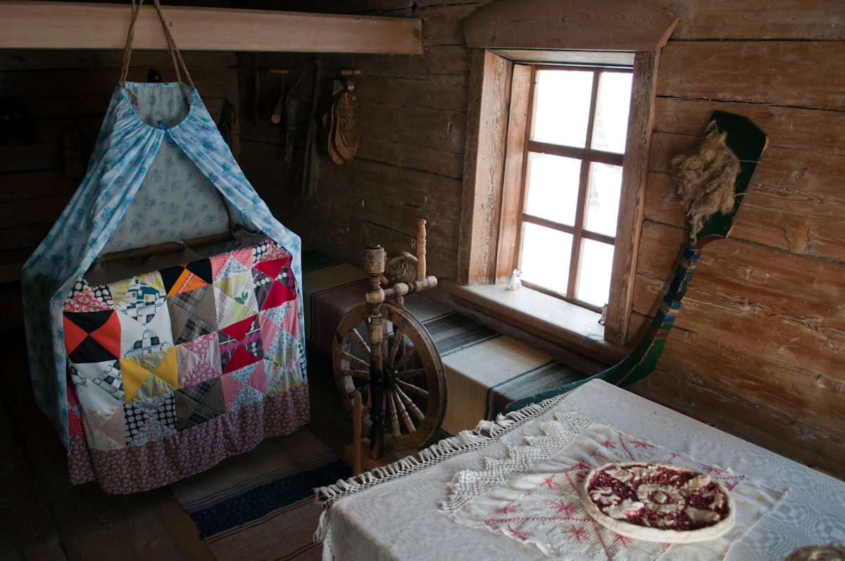 Room with cradle, spindle and table in one of the houses of Angara village in Eastern Siberia.