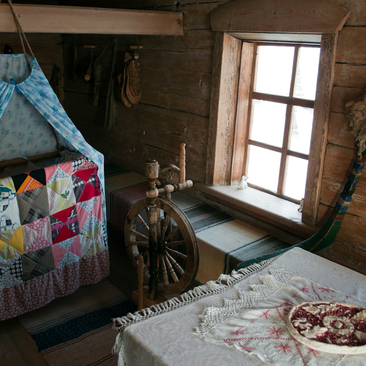Room with cradle, spindle and table in one of the houses of Angara village in Eastern Siberia.