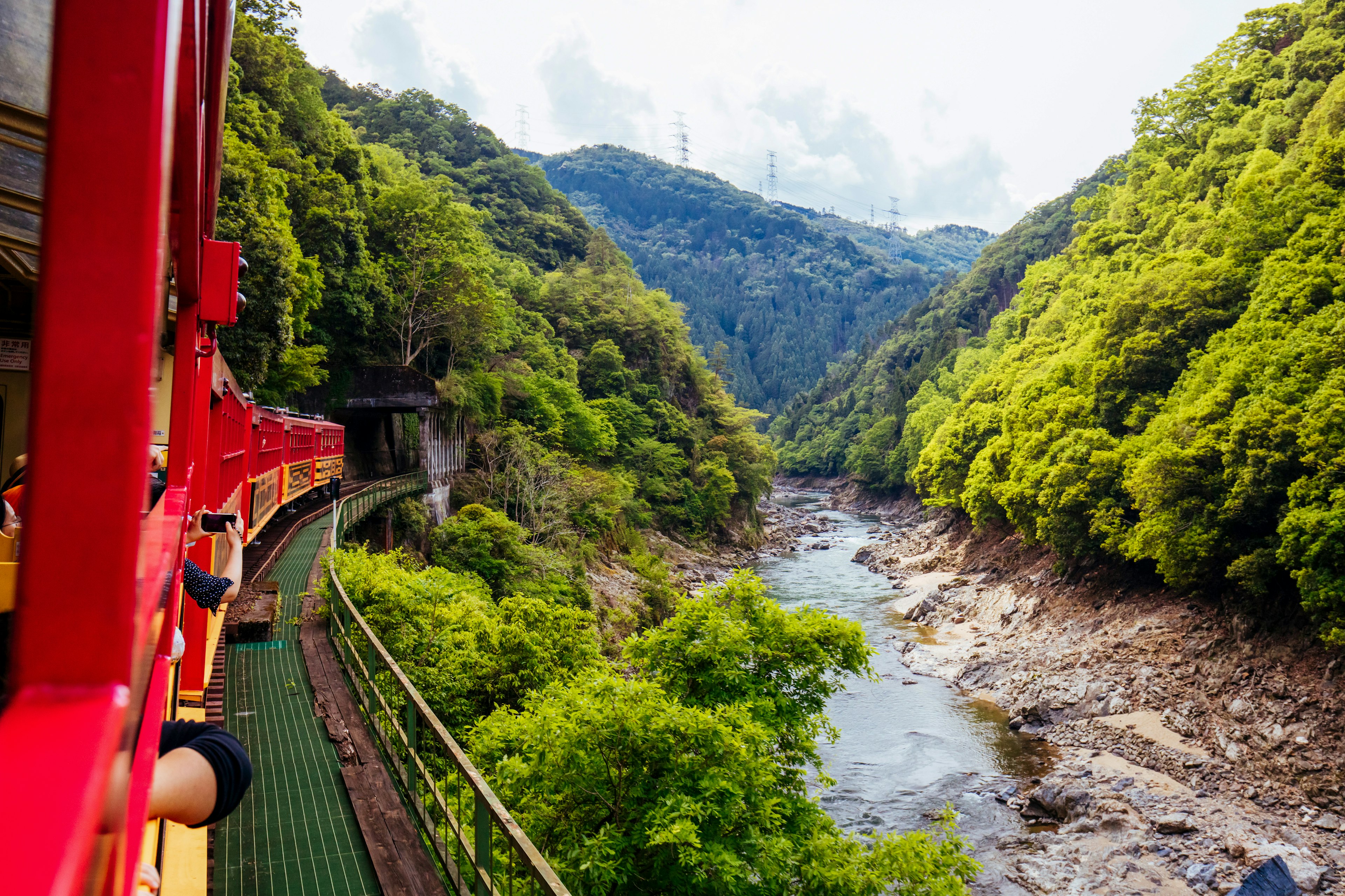 The world-famous Sagano Romantic Train running along the gorge formed by the Katsura River near Kyoto, Japan