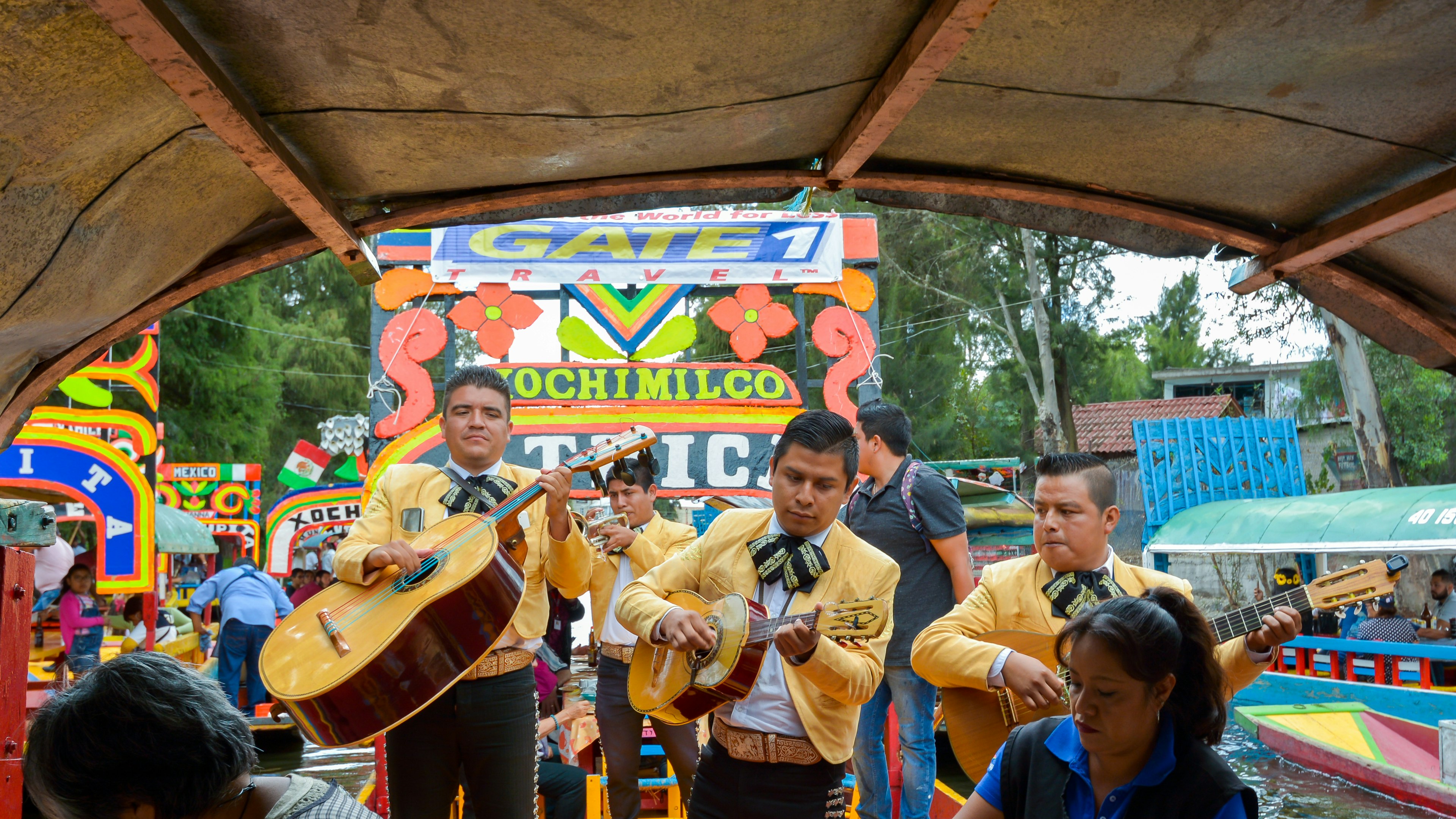 Mariachis entertain tourists on gondola-style trajinera boats on the canals of Xochimilco, Mexico City, Mexicos