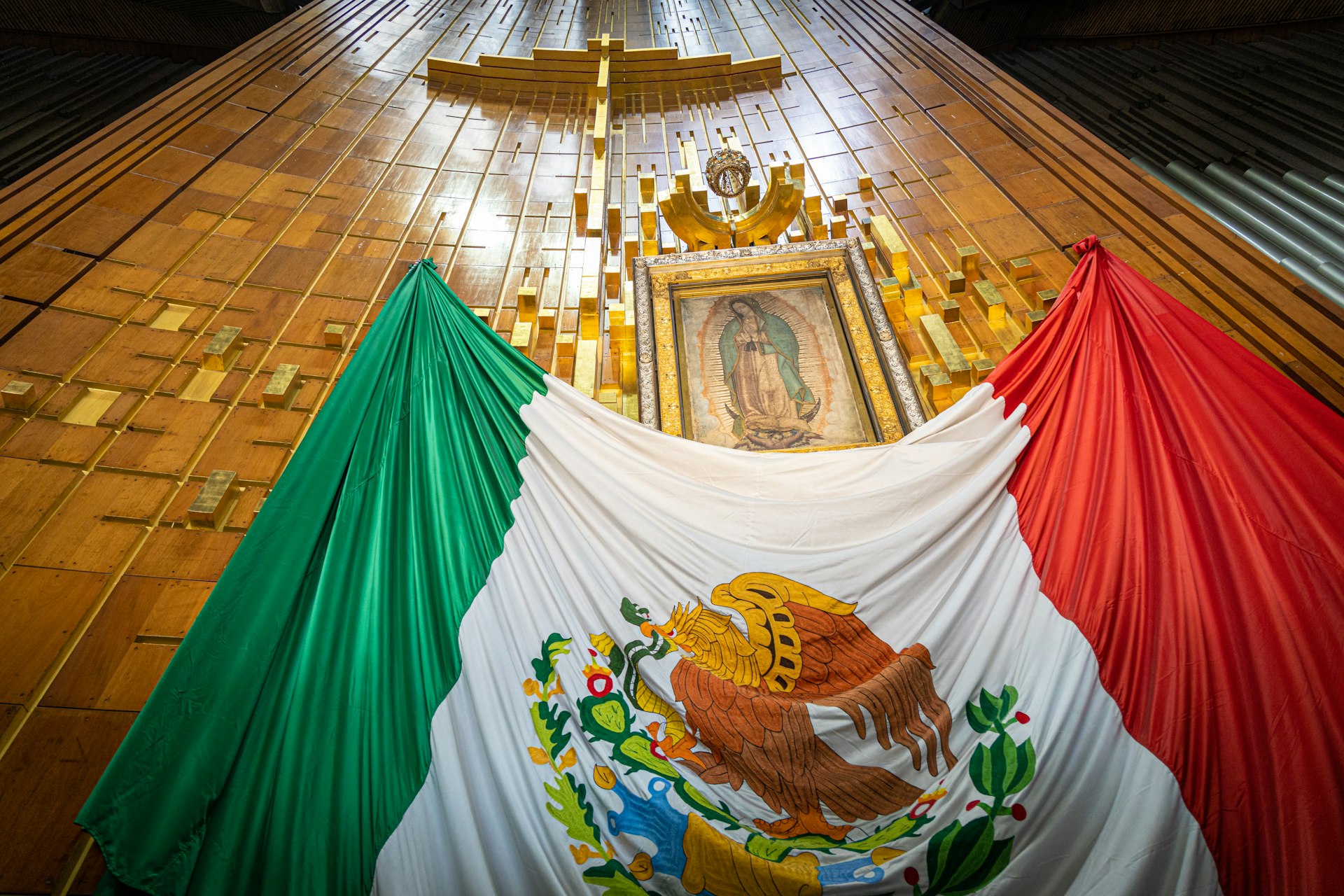 The icon of Nuestra Señora de Guadalupe above a giant Mexican flag, Basílica de Guadalupe, Mexico City, Mexico