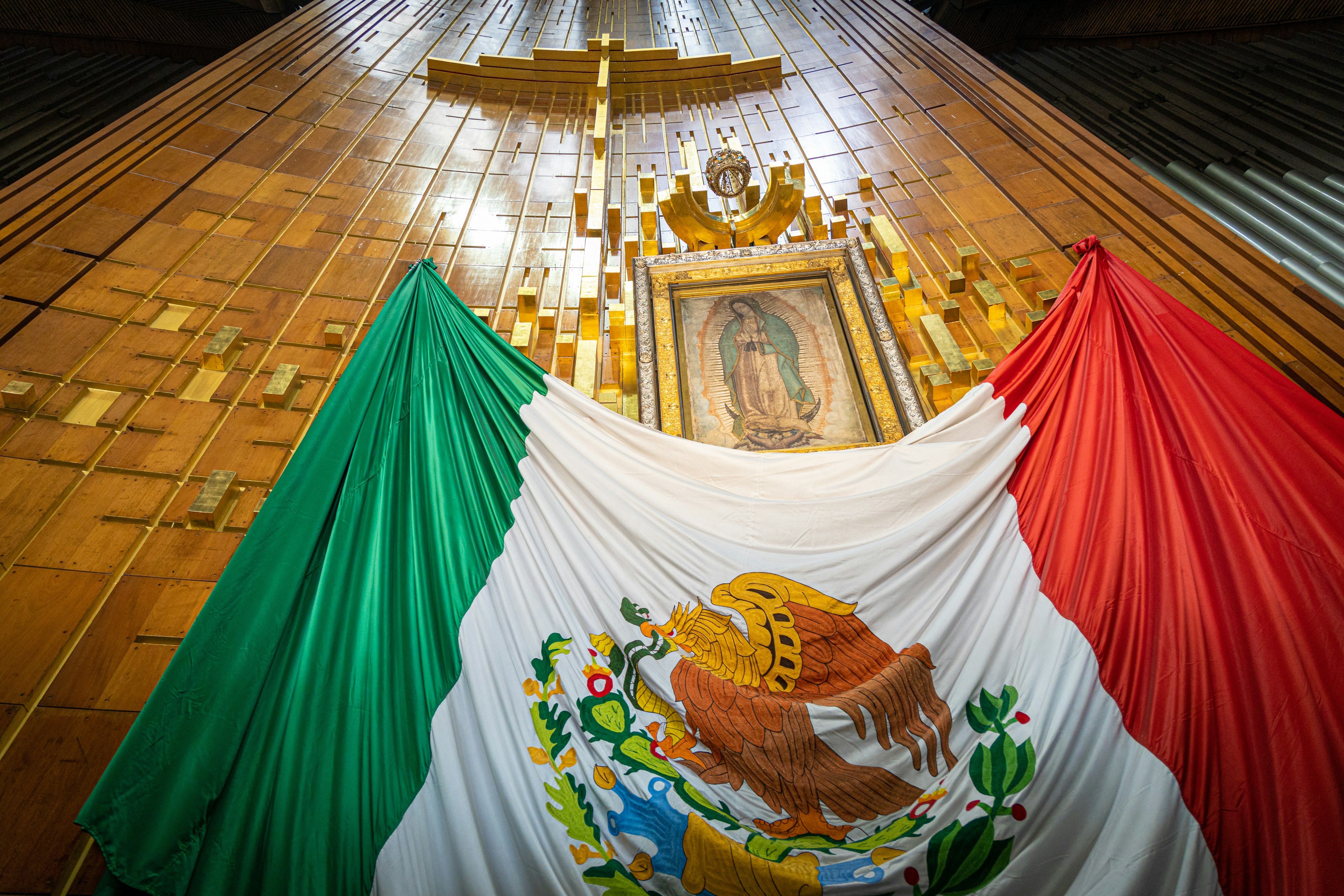 The icon of Nuestra Señora de Guadalupe above a giant Mexican flag, Basílica de Guadalupe, Mexico City, Mexico