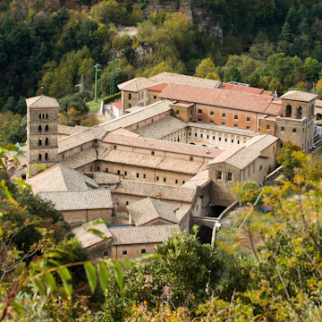 Saint Scholastica medieval monastery surrounded by trees in Subiaco.