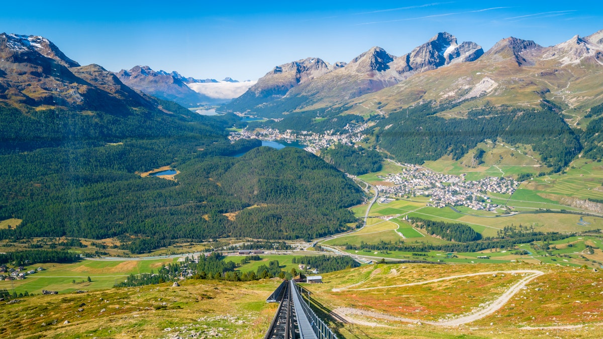 View of Celerina, the Upper Engadine Valley and the four Upper Engadine Lakes from inside the Mouttas Muragl Bahn funicular train, waiting at the top station Muottas Muragl.