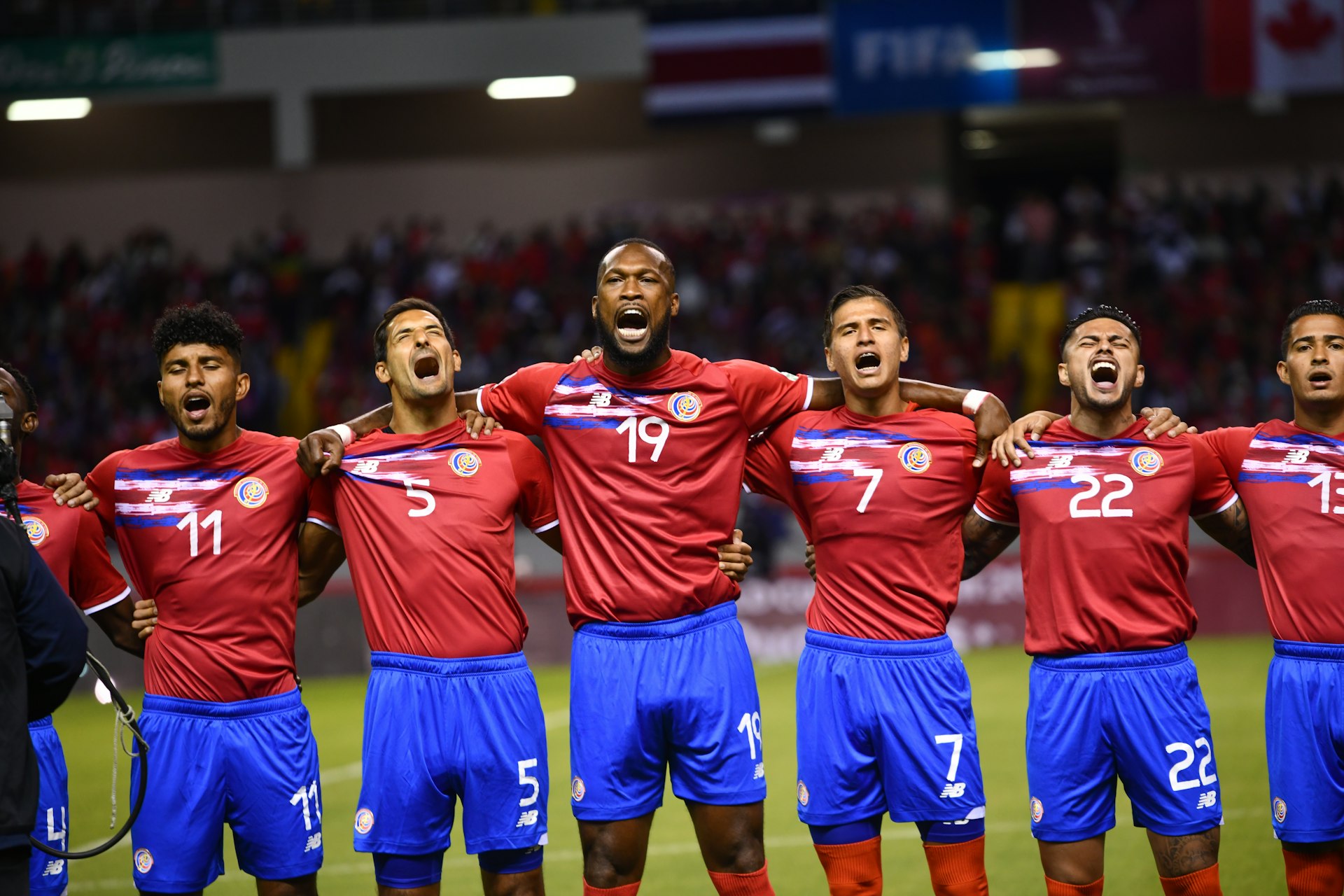 Costa Rican team sings the national anthem before the start of the match against Canada