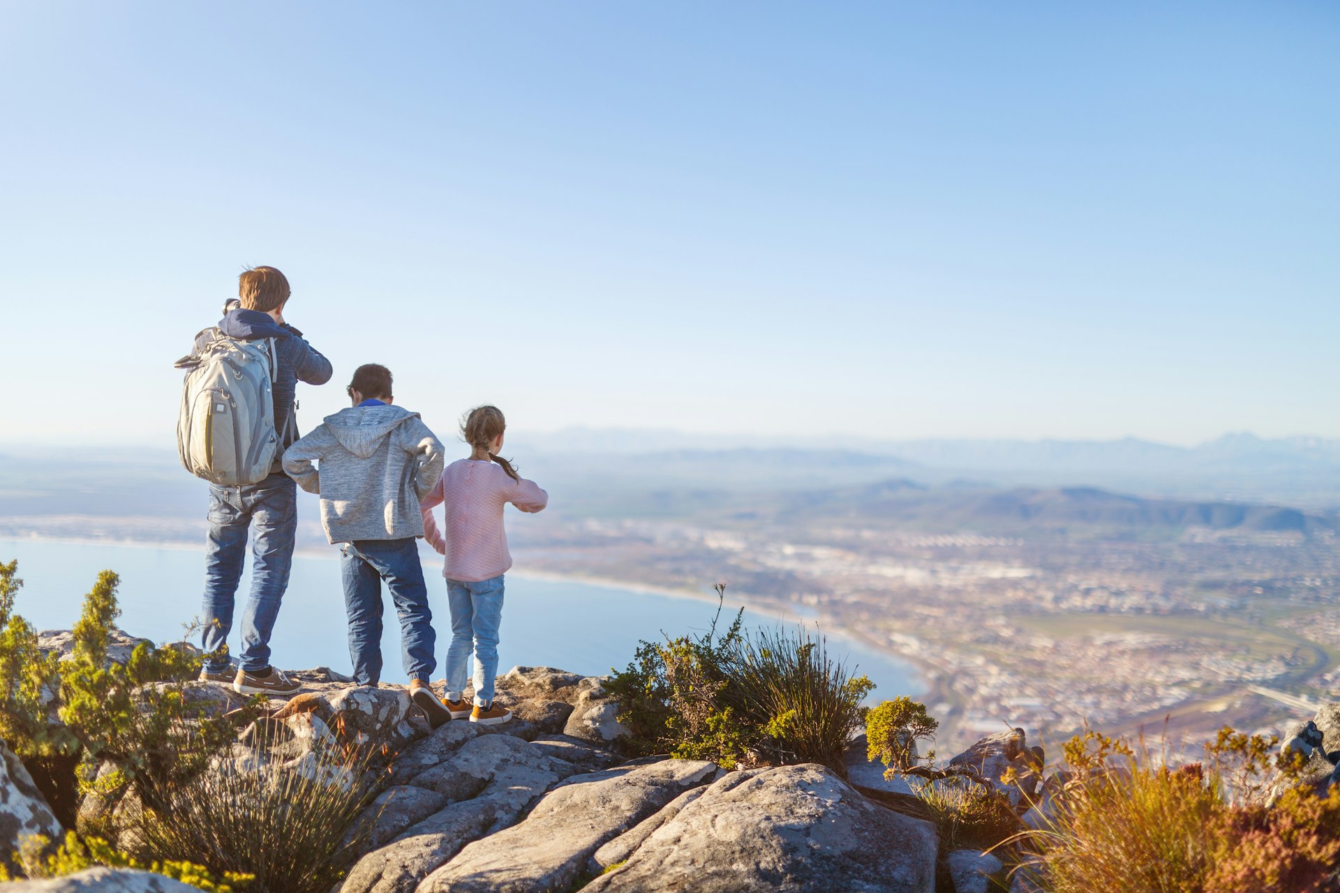 Family with two kids enjoying breathtaking views of Cape Town from top of Table mountain
